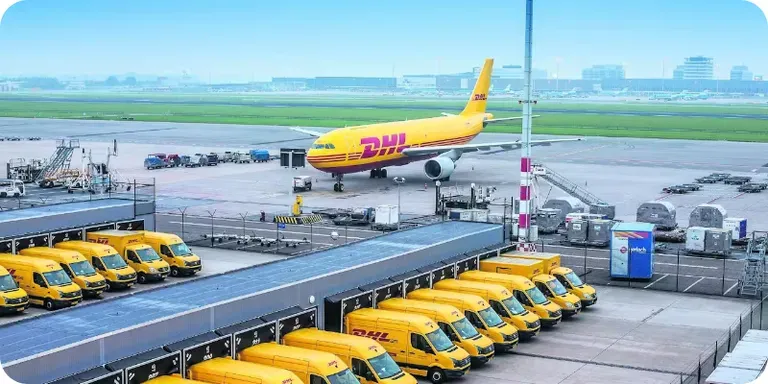 A DHL cargo plane and a row of yellow vans on the apron