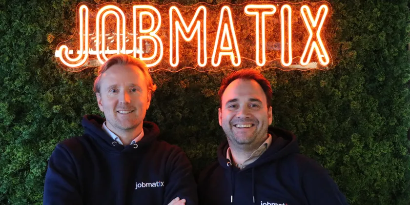 Wiebe Mulder and Peter Woudenberg in front of a moss wall with the Jobmatix logo in neon letters